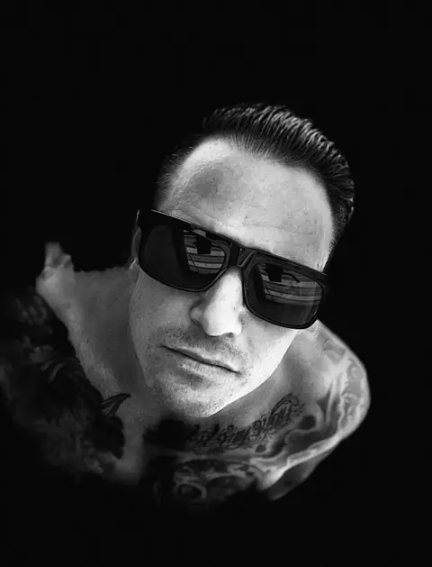 Black-and-white overhead portrait of Michael Jannicelli wearing sunglasses